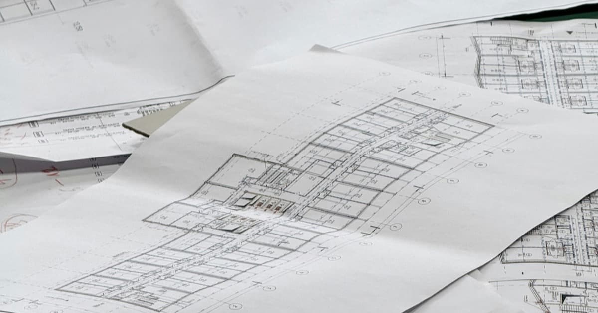 Architectural floor-plan drawings spread across a flat surface.