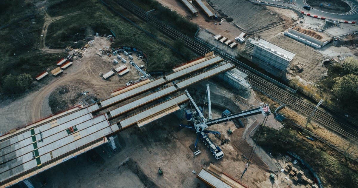 Bird's-eye view of a highway construction site with machinery and part-built structures.